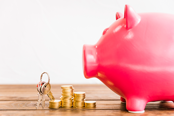 Piggy bank with coins and a set of keys