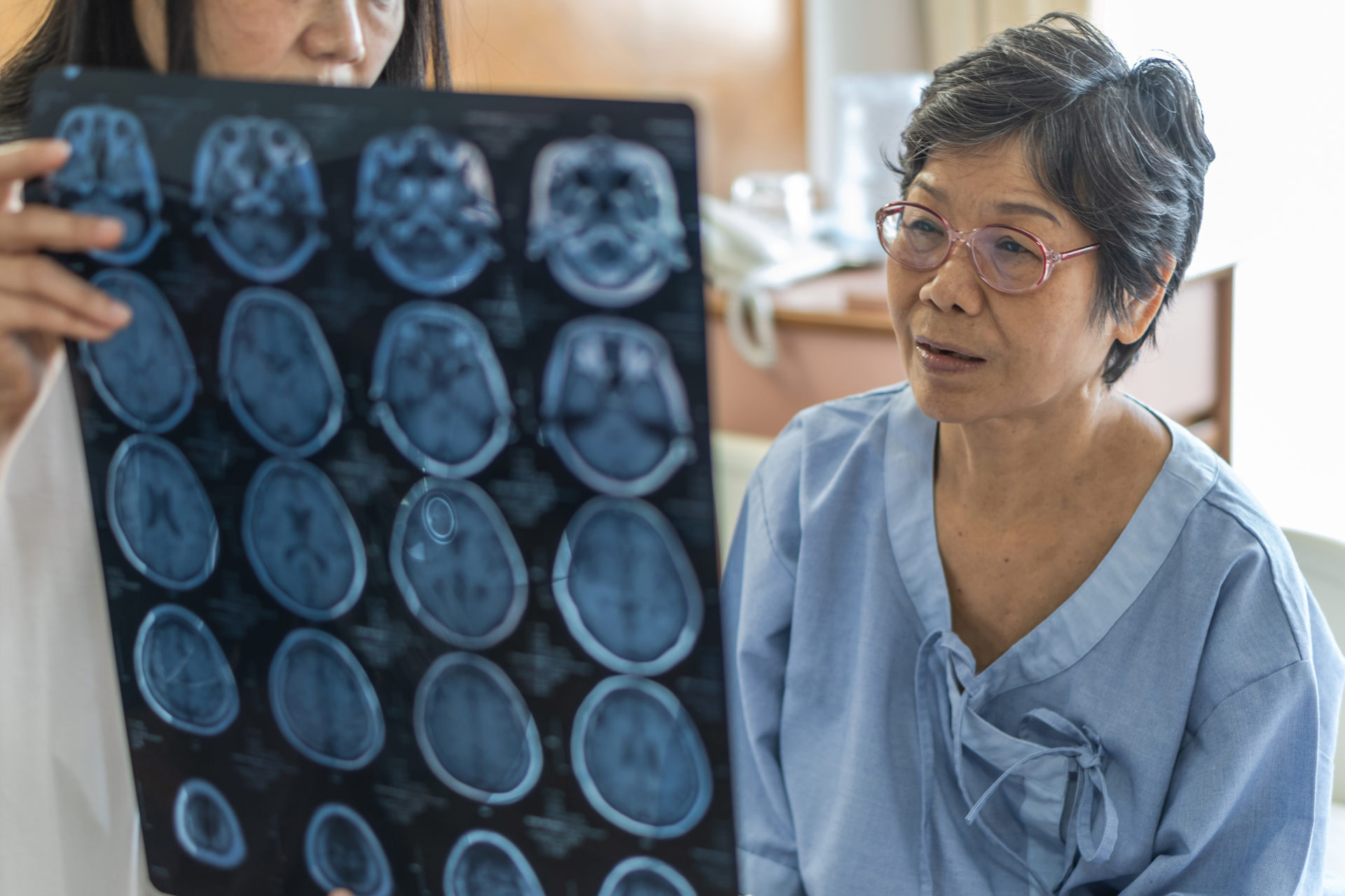 patient and doctor study brain scan